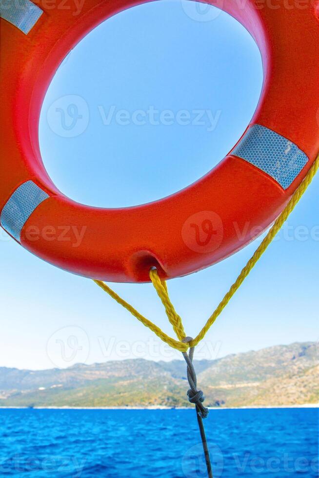 Orange lifebuoy on a back of blue sky. photo