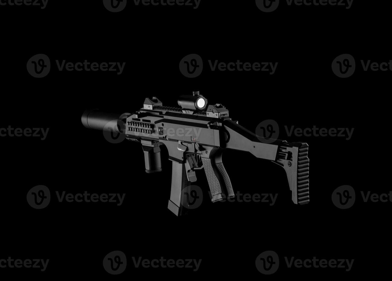 Modern automatic rifle isolated on black background. Weapons for police, special forces and the army. A carbine with optical, mechanical sights and a silencer on a dark background. photo