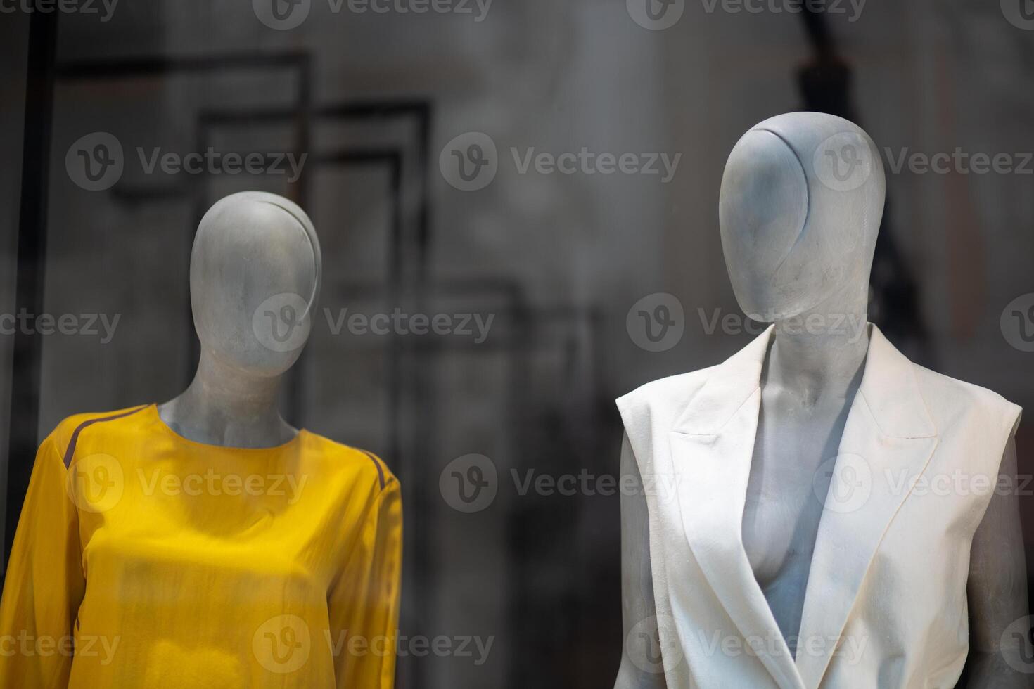 Two mannequins in a shop window. Modern mannequin for displaying clothes. photo