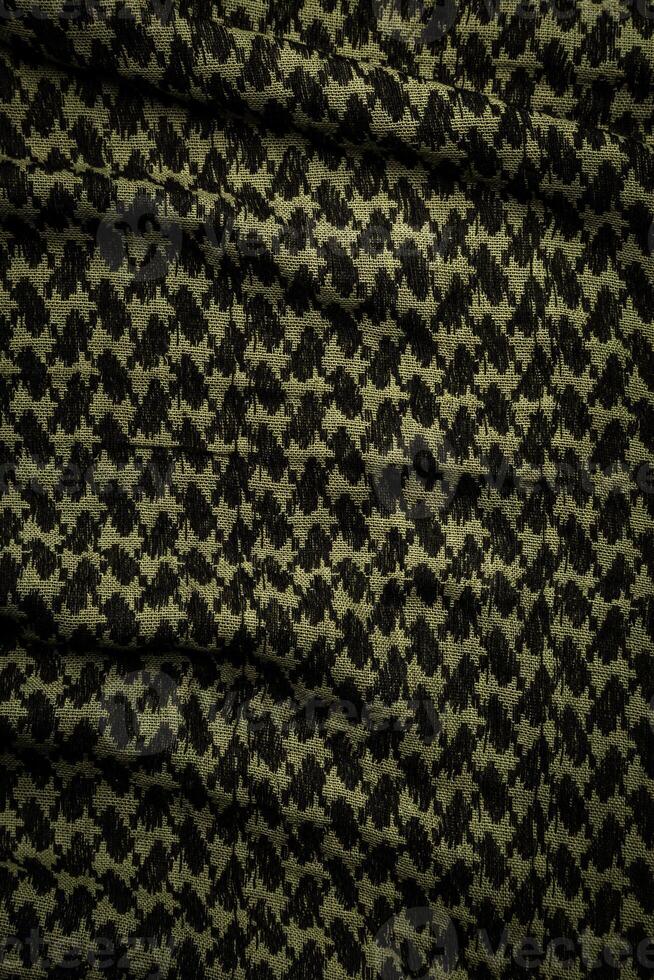 Keffieh scarf. The texture of the cotton traditional symbolic arabian scarf. Khaki back. photo