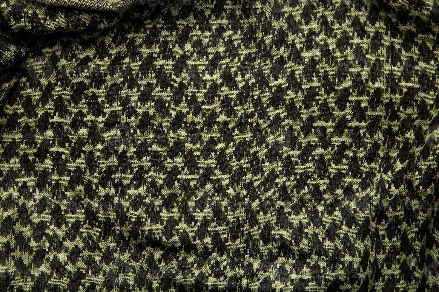 Keffieh scarf. The texture of the cotton traditional symbolic arabian scarf. Khaki back. photo