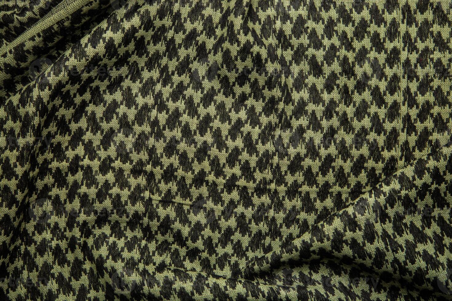 Keffieh scarf. The texture of the cotton traditional symbolic arabian scarf. Khaki back. photo