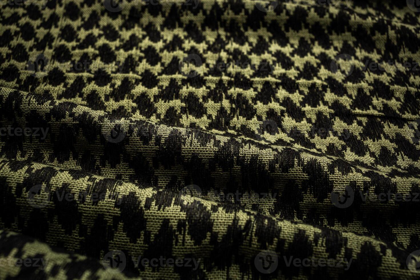 Keffieh scarf. The texture of the cotton traditional symbolic arabian scarf. Close-up material. Khaki back. photo