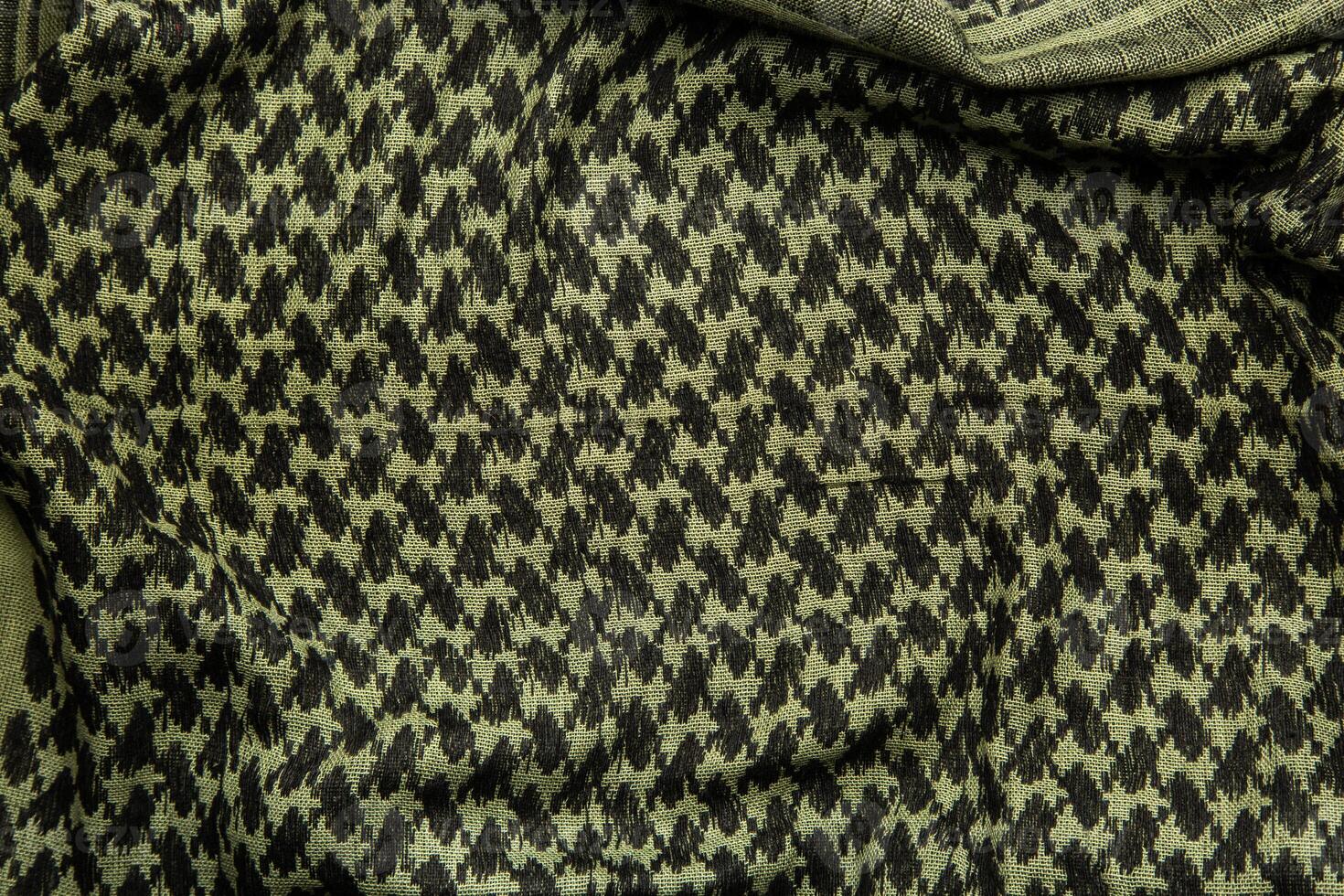 Keffieh scarf. The texture of the cotton traditional symbolic arabian scarf. Khaki back. photo