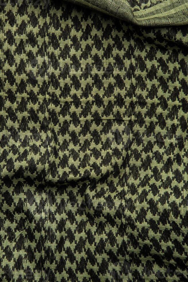 Keffieh scarf. The texture of the cotton traditional symbolic arabian scarf. Khaki back. photo