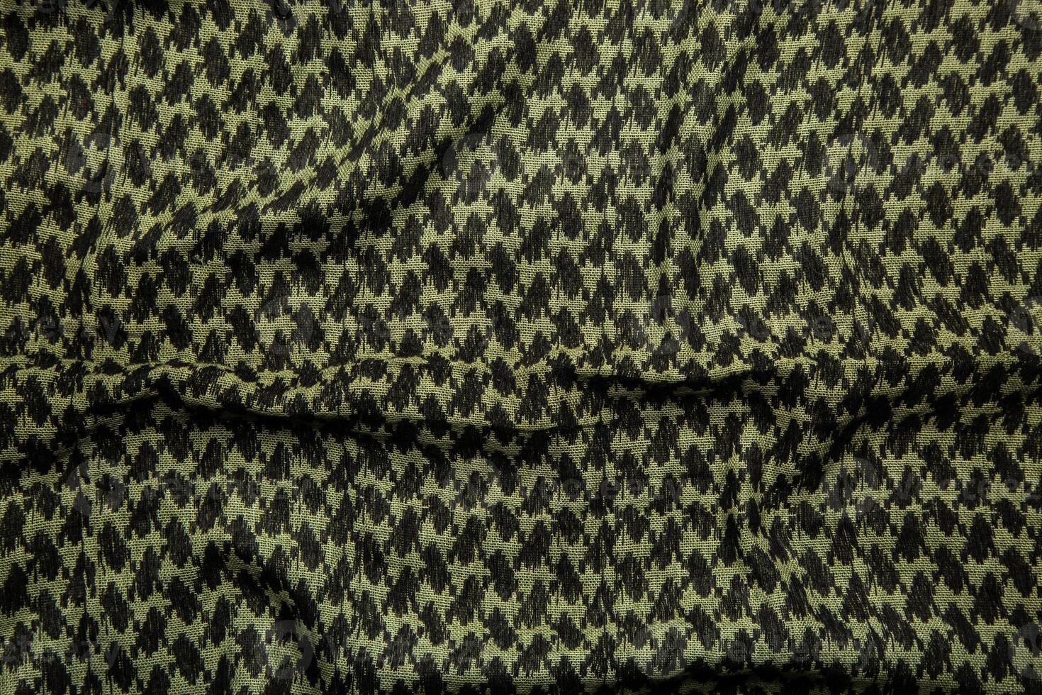 Keffieh scarf. The texture of the cotton traditional symbolic arabian scarf. Khaki back. photo