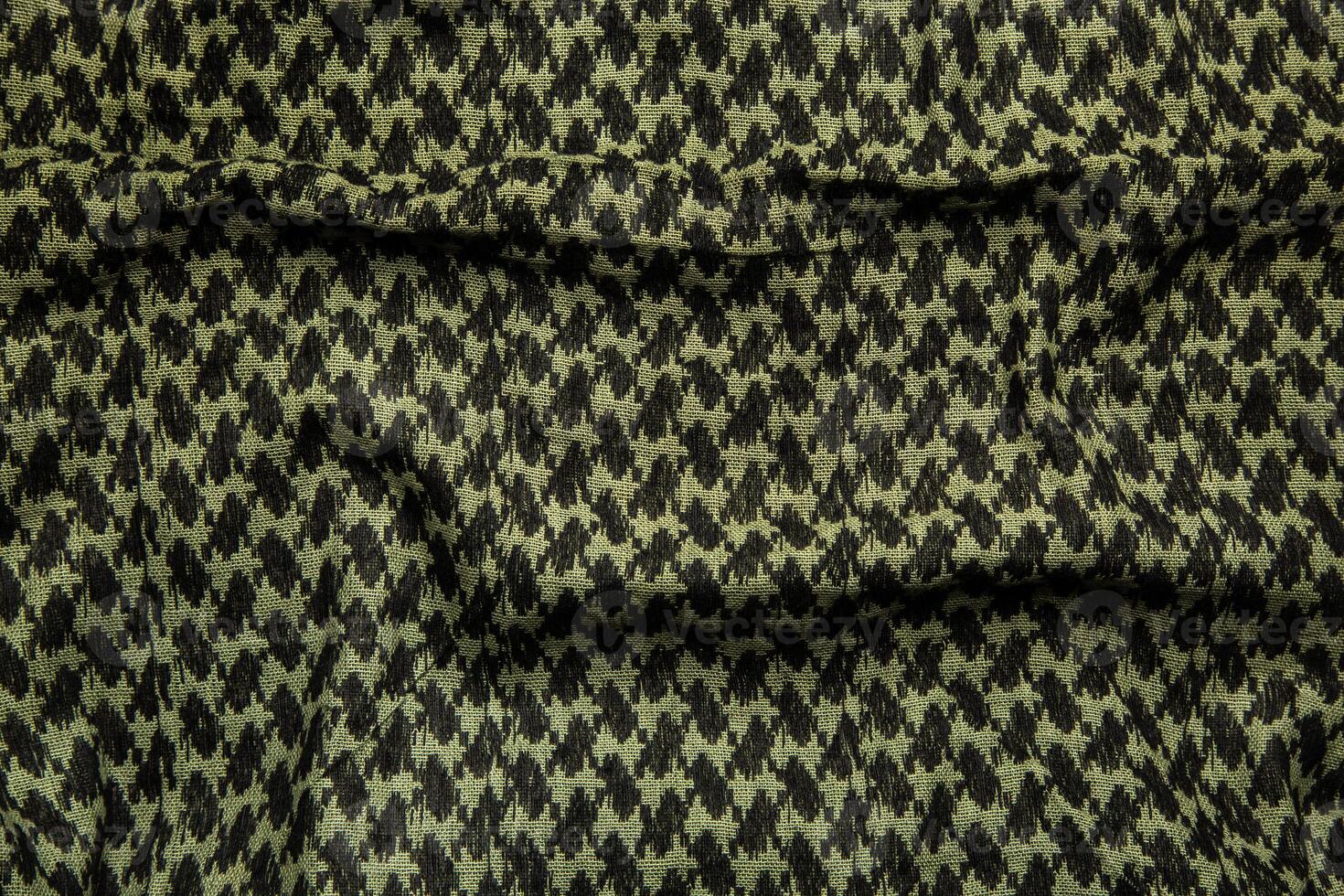 Keffieh scarf. The texture of the cotton traditional symbolic arabian scarf. Khaki back. photo