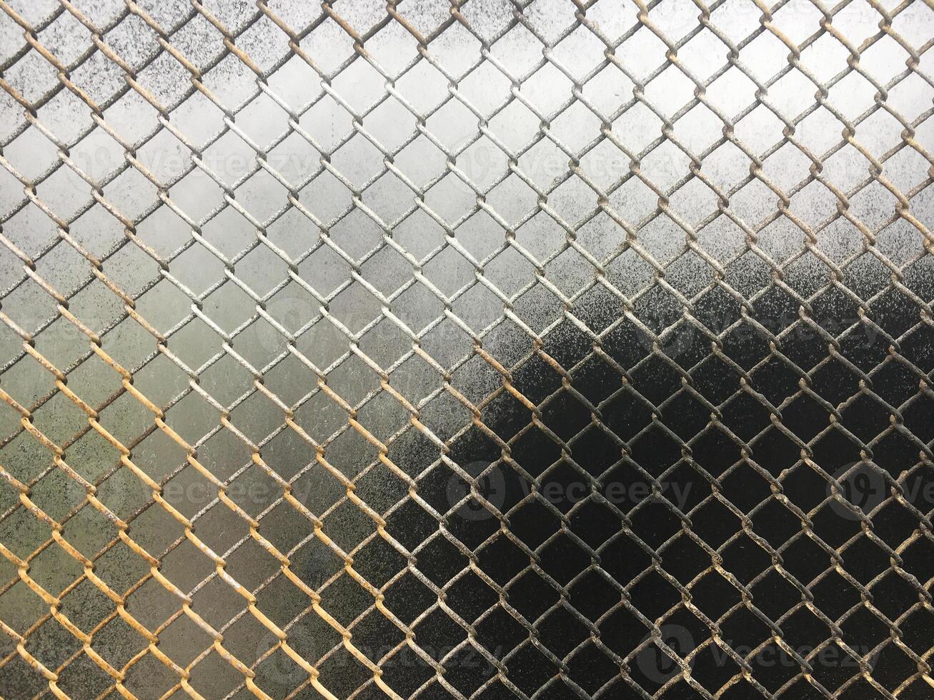 The texture of the old metal mesh of the chain. Old grid background. photo