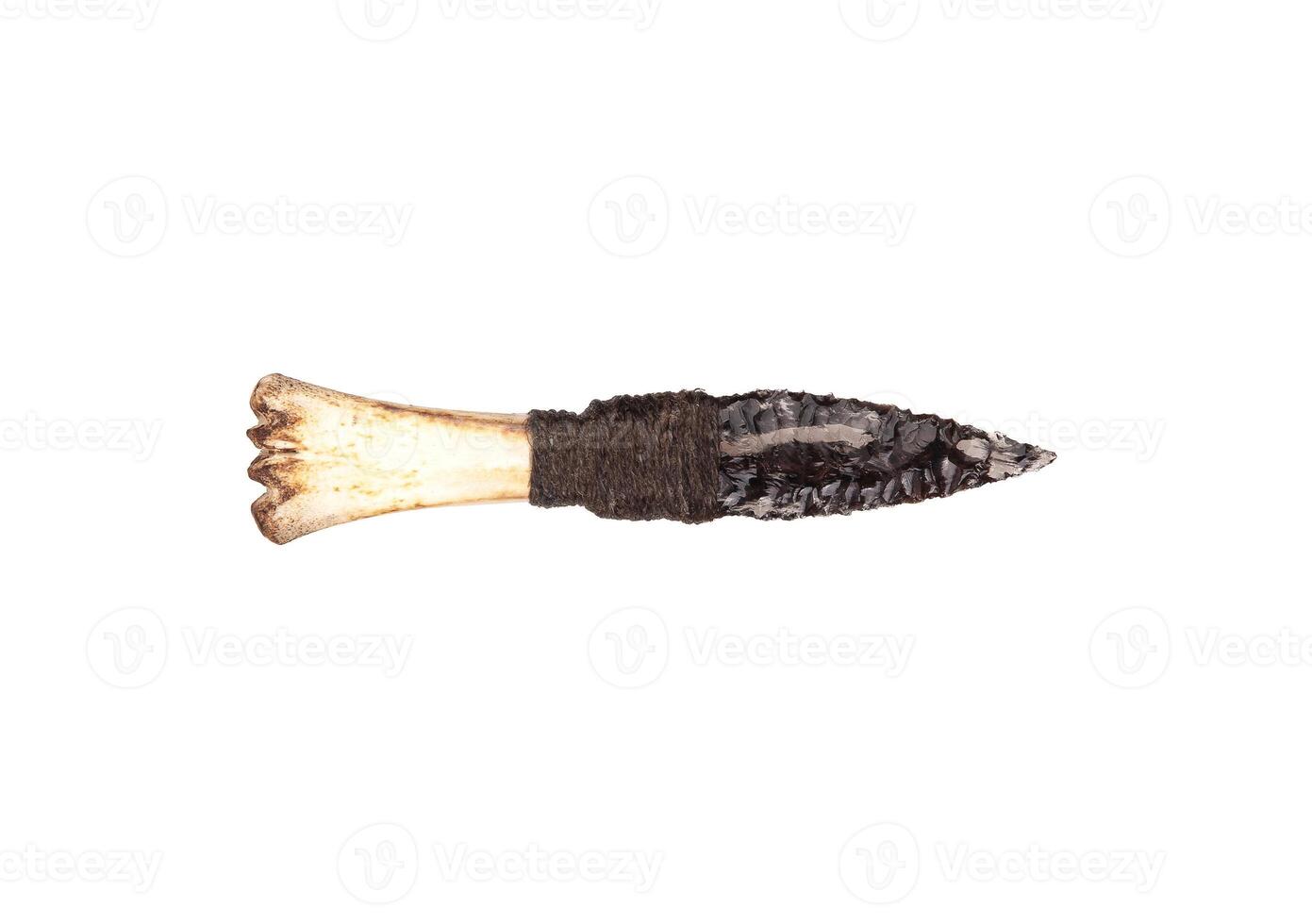 Obsidian knife with bone handle isolate on a white back. Prehistoric weapon made of volcanic glass. photo