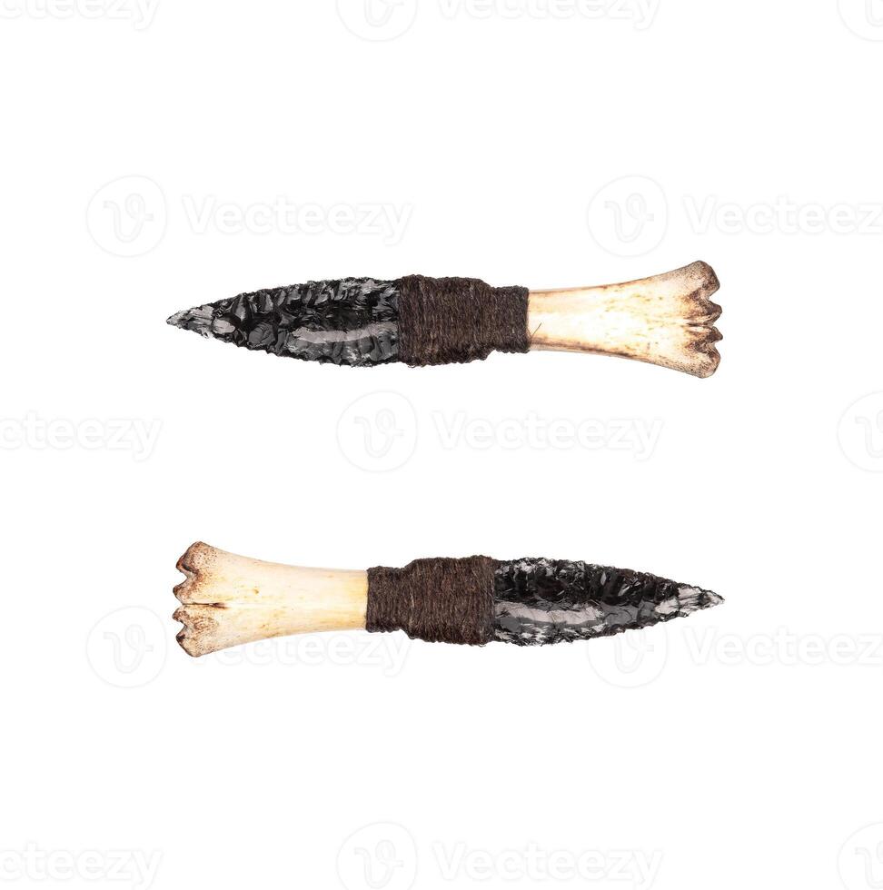 Obsidian knife with bone handle isolate on a white back. Prehistoric weapon made of volcanic glass. photo
