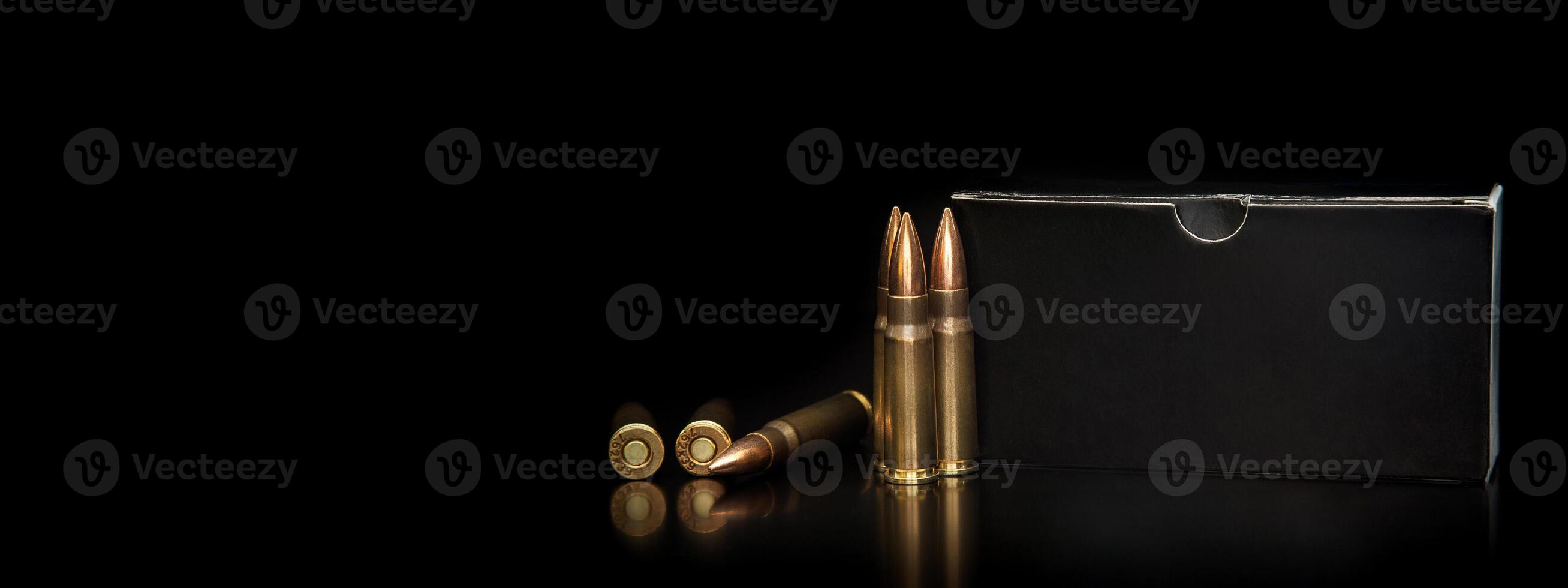 Bullet isolated on black background with reflexion. Rifle bullets close-up on black back. Cartridges for rifle and carbine on a black. photo