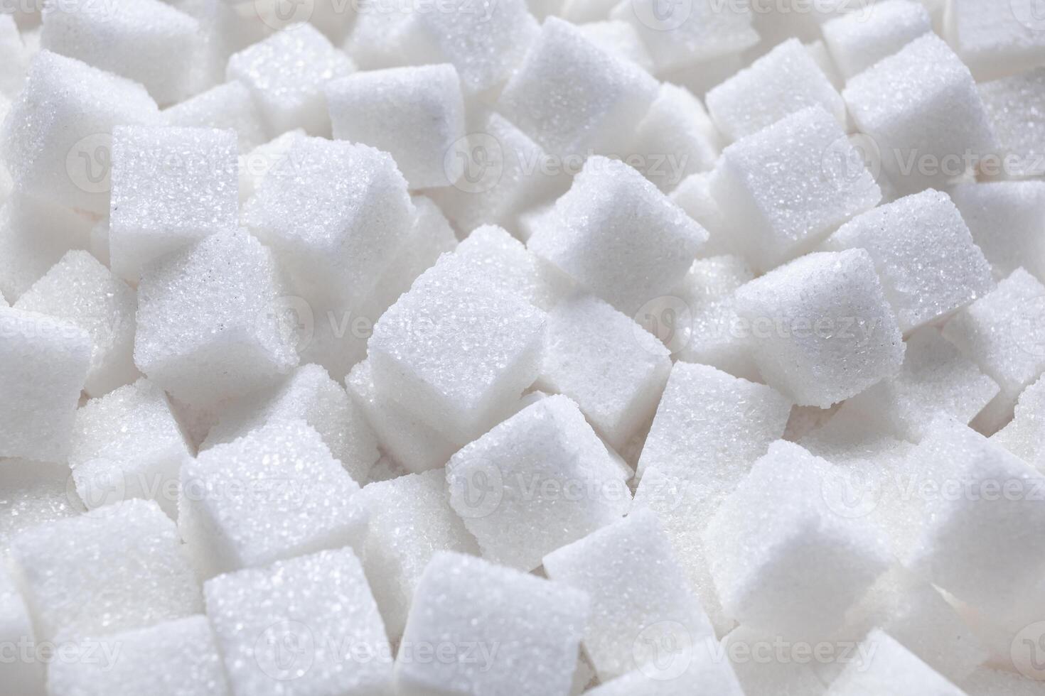 Rafinated sugar. Textured white background from sugar cubes. photo
