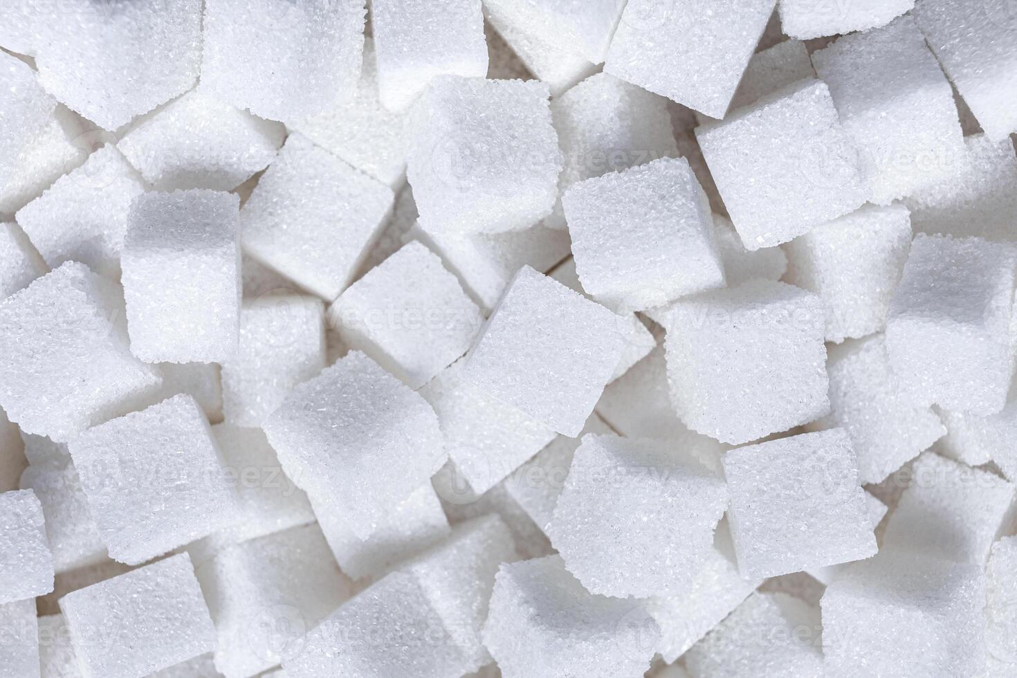 Rafinated sugar. Textured white background from sugar cubes. photo