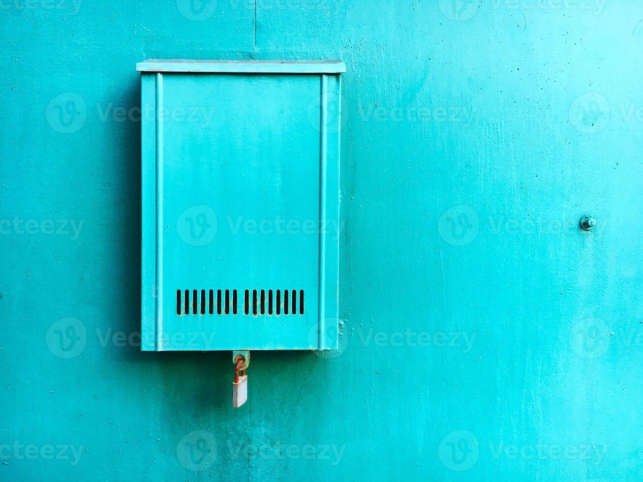 Blue mailbox on the blue wall photo
