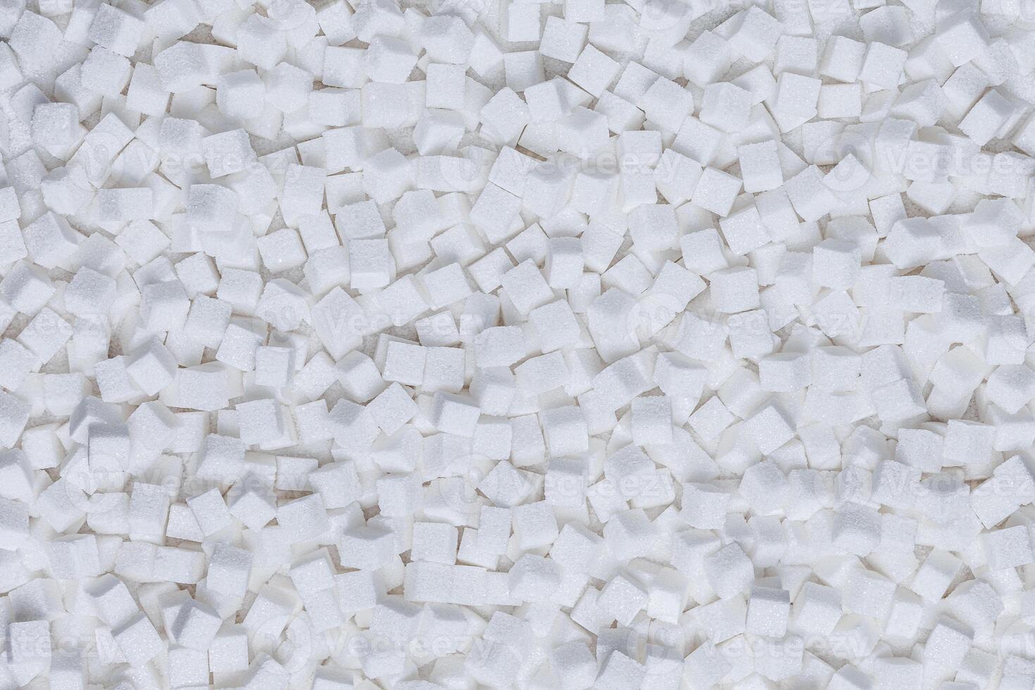 Rafinated sugar. Textured white background from sugar cubes. photo