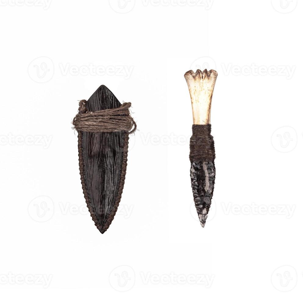 Obsidian knife with bone handle isolate on a white back. Prehistoric weapon made of volcanic glass. photo