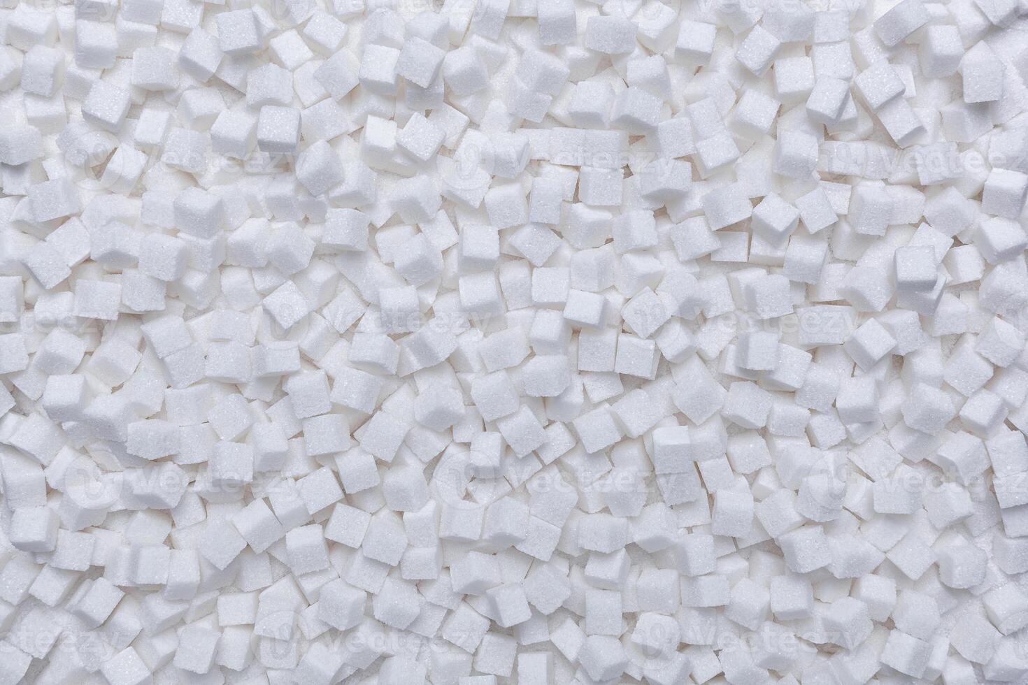 Rafinated sugar. Textured white background from sugar cubes. photo