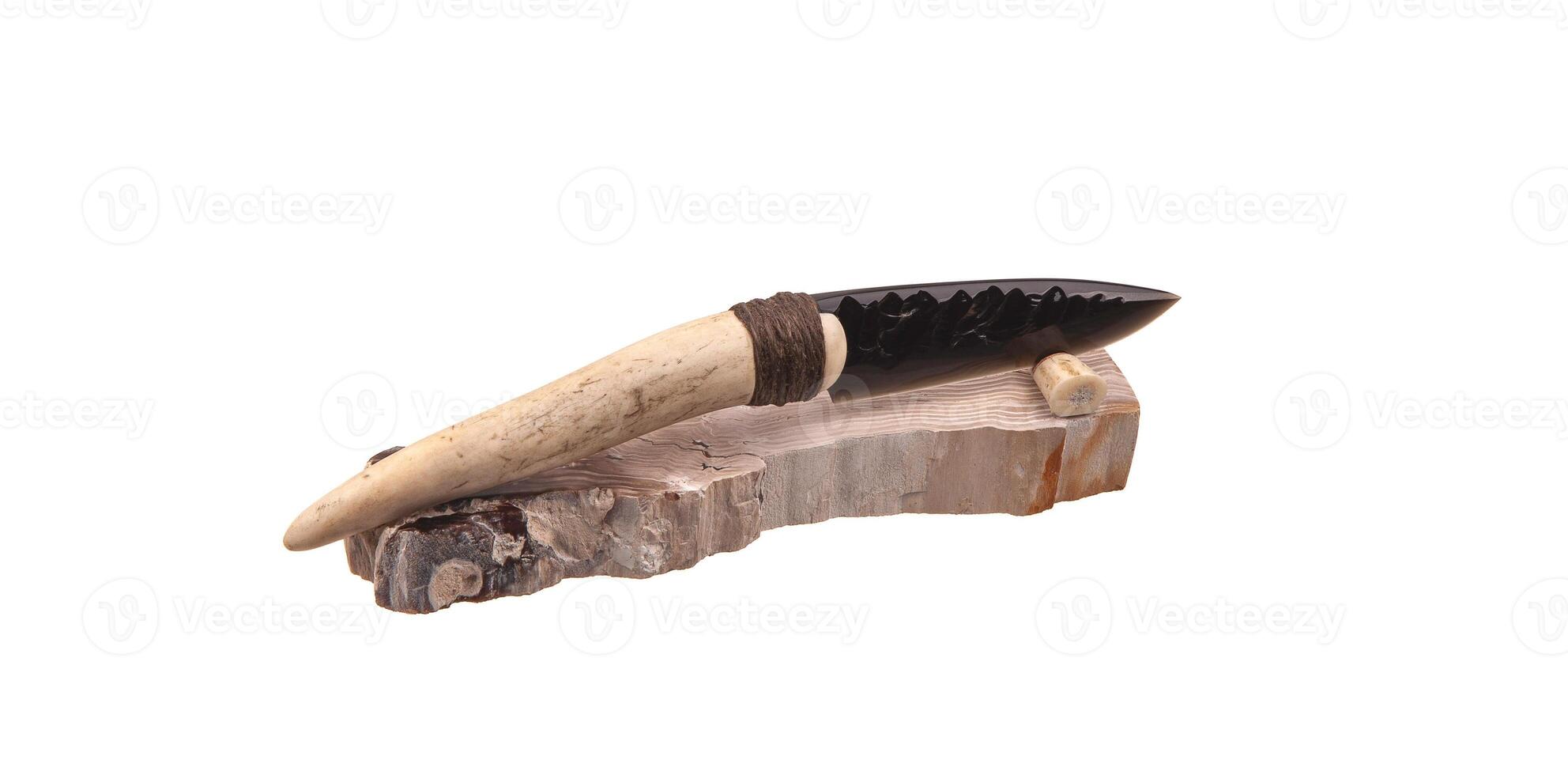 Obsidian knife with bone handle isolate on a white back. Prehistoric weapon made of volcanic glass. photo