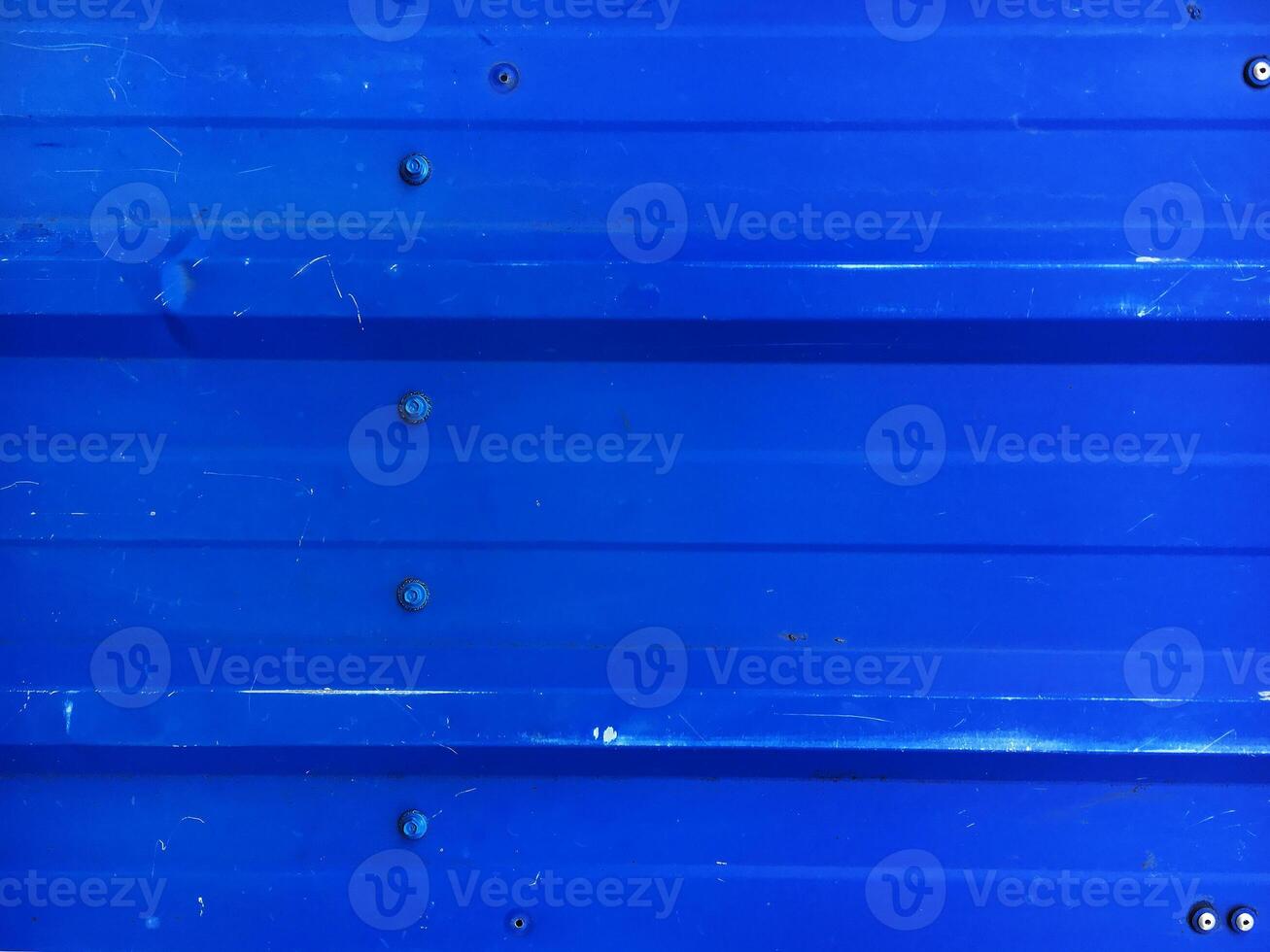 Blue rippled metal texture with bolts photo