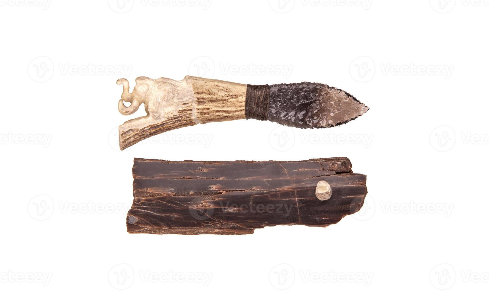 Obsidian knife with bone handle isolate on a white back. Prehistoric weapon made of volcanic glass. photo