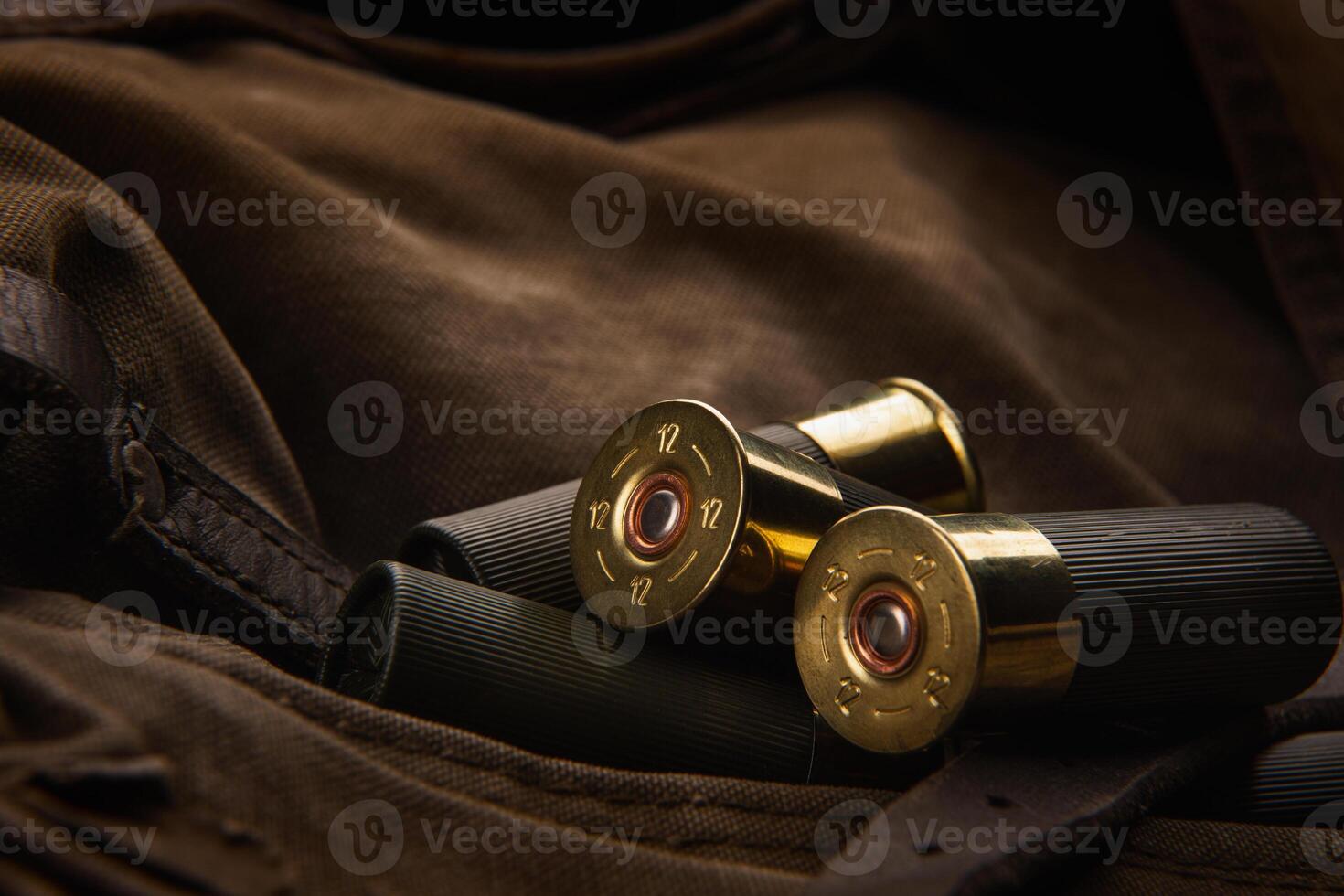 Shotgun shells close-up. Ammunition for smoothbore weapons on a khaki canvas backpack. Dark back photo