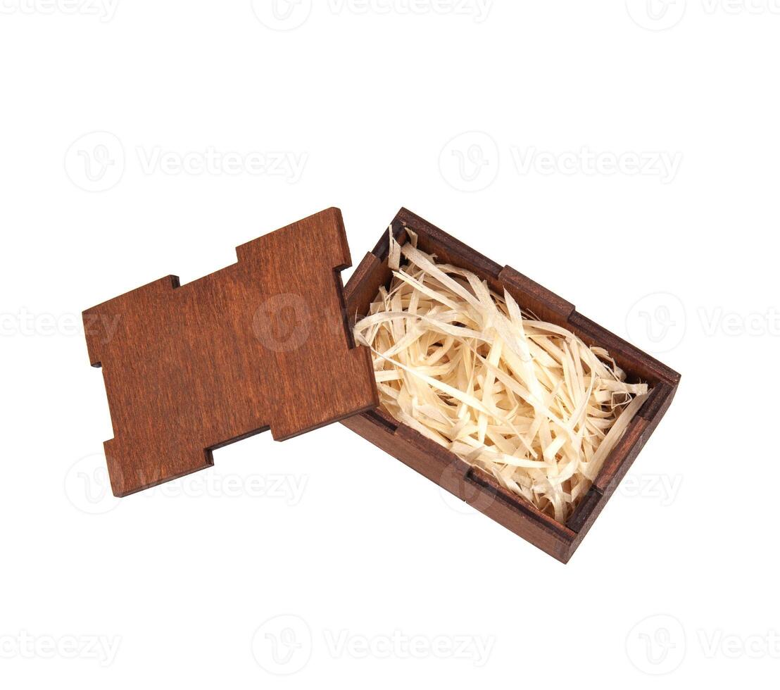 Open wooden box with filling material inside. Empty natural wooden box with decorative straw for happy gifts. photo