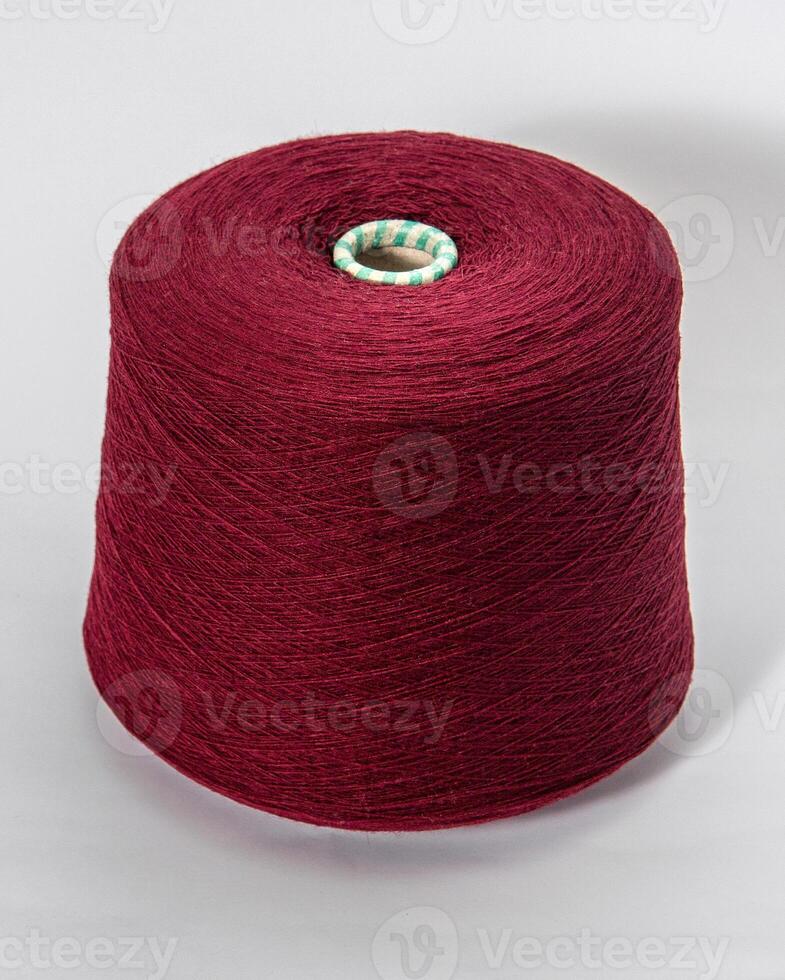 bobbin of yarn on a white background. Side view.Textile reel on isolated white background. photo