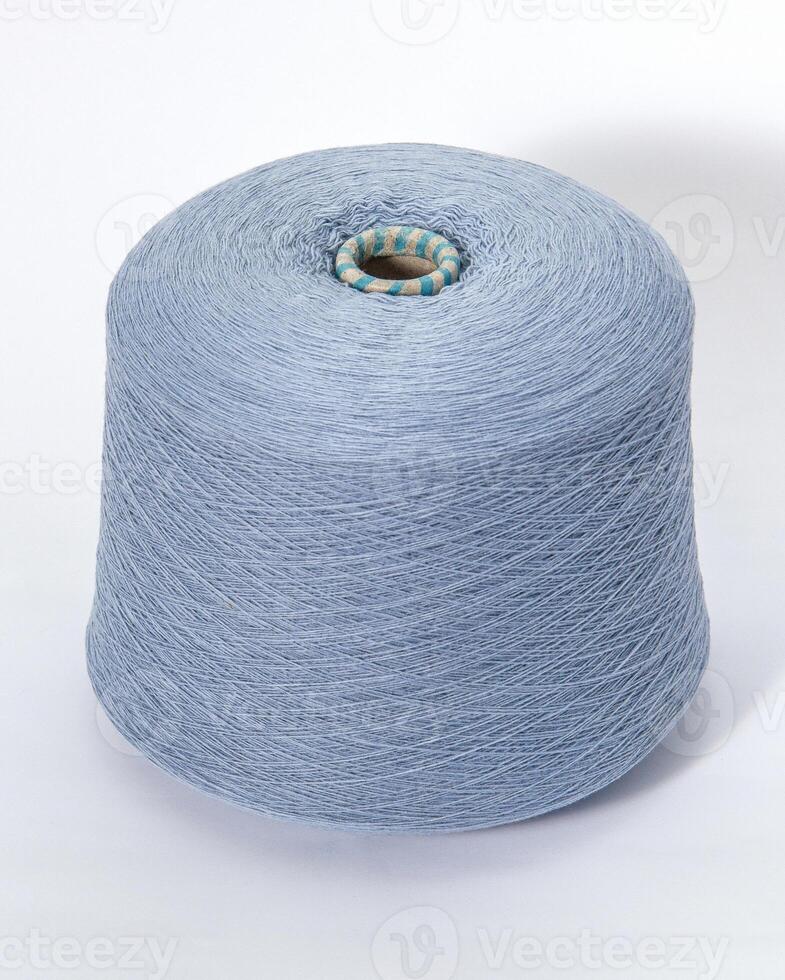 bobbin of yarn on a white background. Side view.Textile reel on isolated white background. photo
