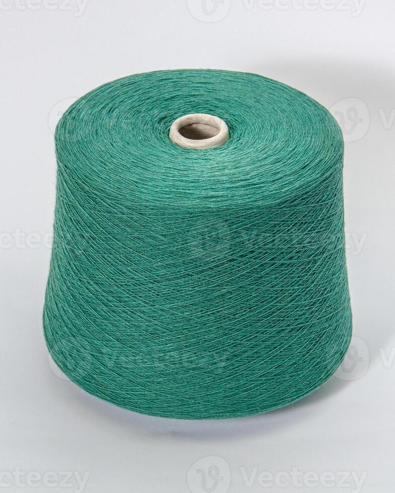 bobbin of yarn on a white background. Side view.Textile reel on isolated white background. photo