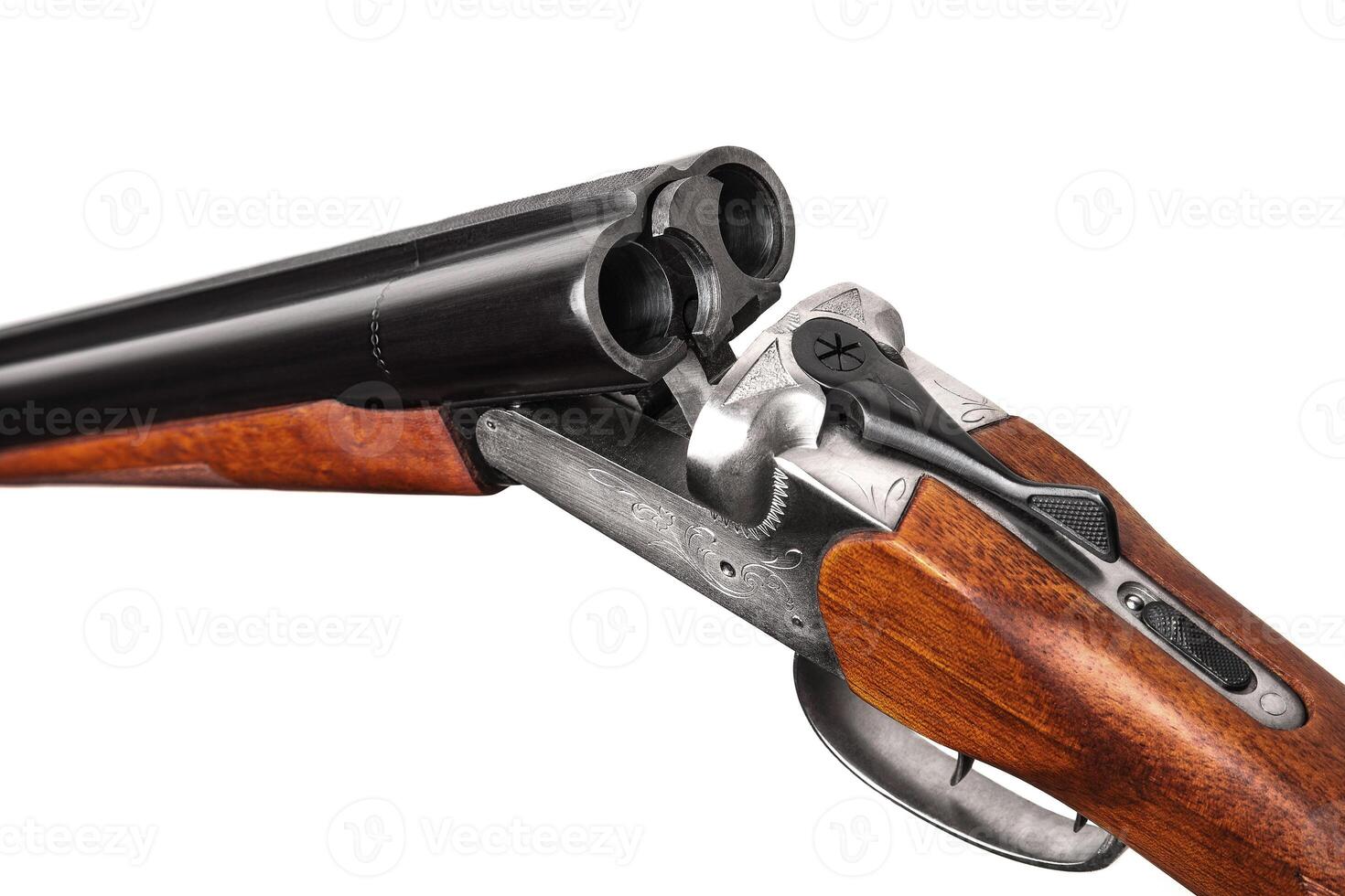 Close-up of an open classic double-barreled hunting shotgun. Weapons for hunting and sport isolate on a white background. Shotgun with a wooden butt. photo