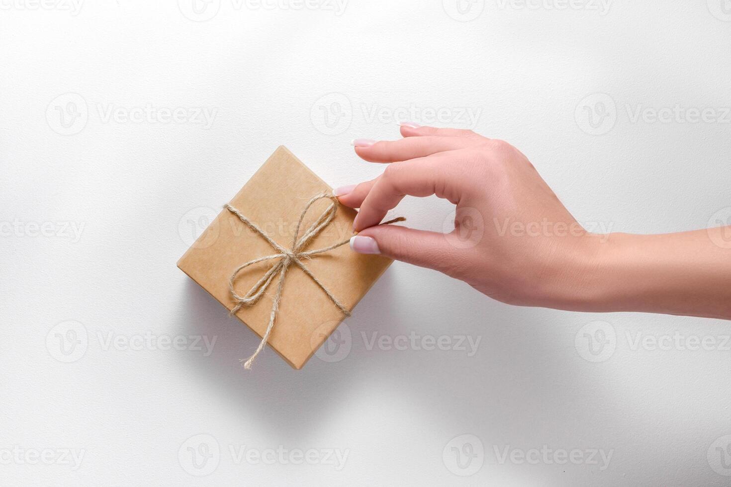 girl's hand opening gift box isolated on white photo