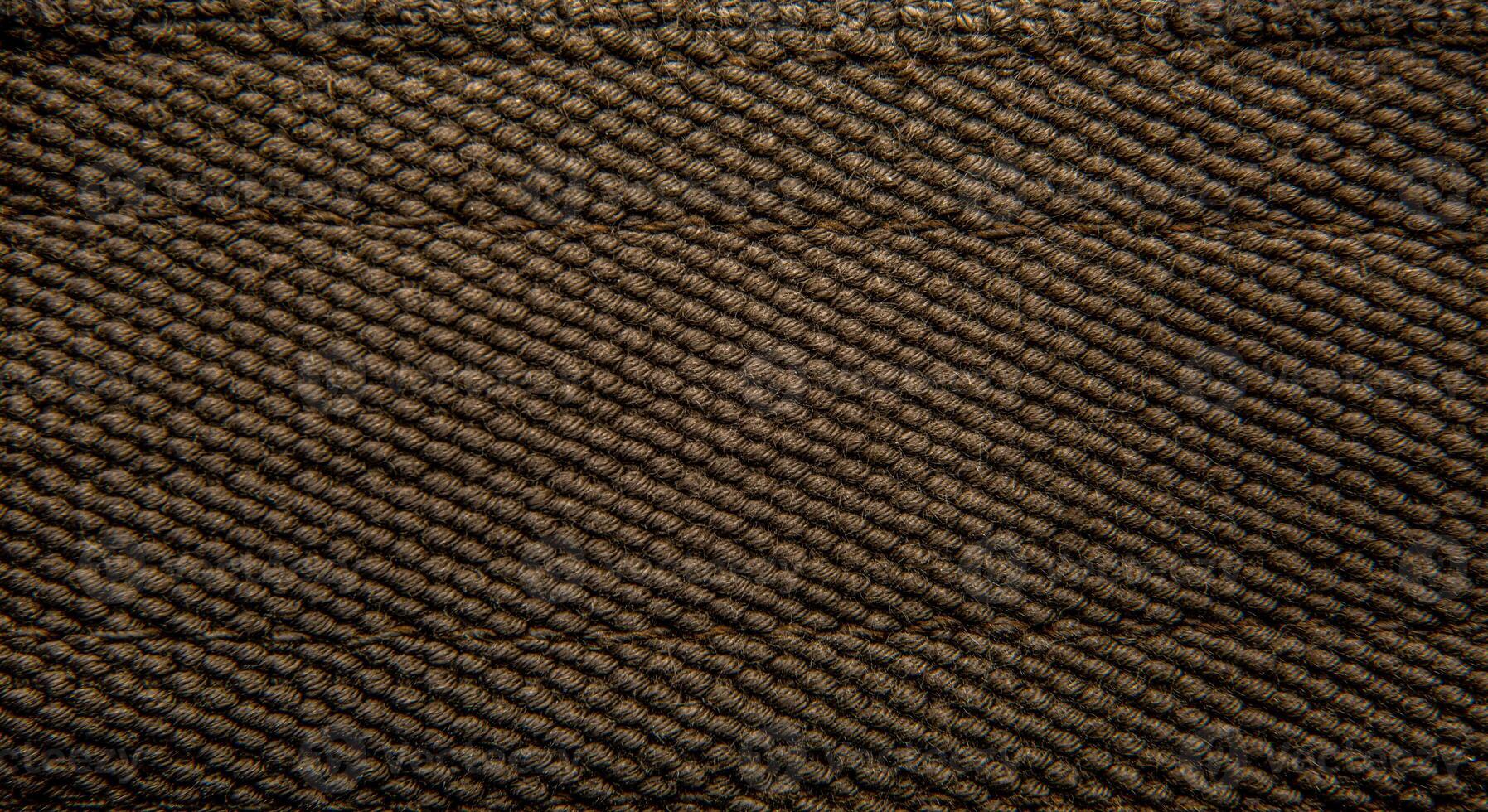 Close-up texture of a canvas fabric backpack. Leather straps and metal buckles. Vintage khaki back. photo