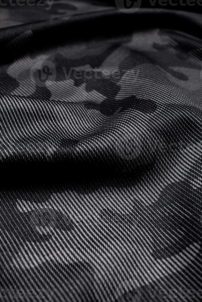 Camouflage pattern. Trendy dark gray camouflage fabric. Military texture. Dark back. photo