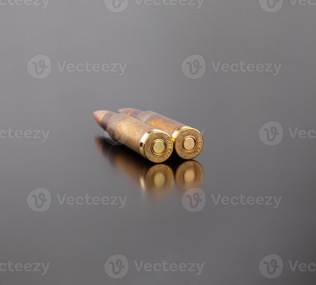 Bullet isolated on black background with reflexion. Rifle bullets close-up on black back. Cartridges for rifle and carbine on a black. photo
