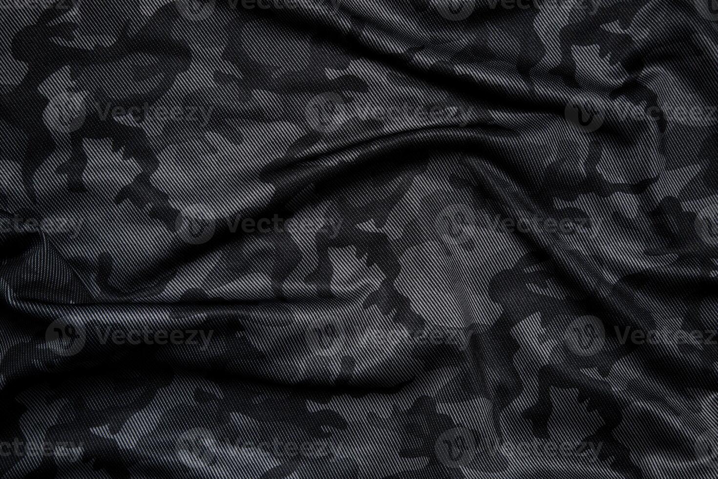Camouflage pattern. Trendy dark gray camouflage fabric. Military texture. Dark back. photo