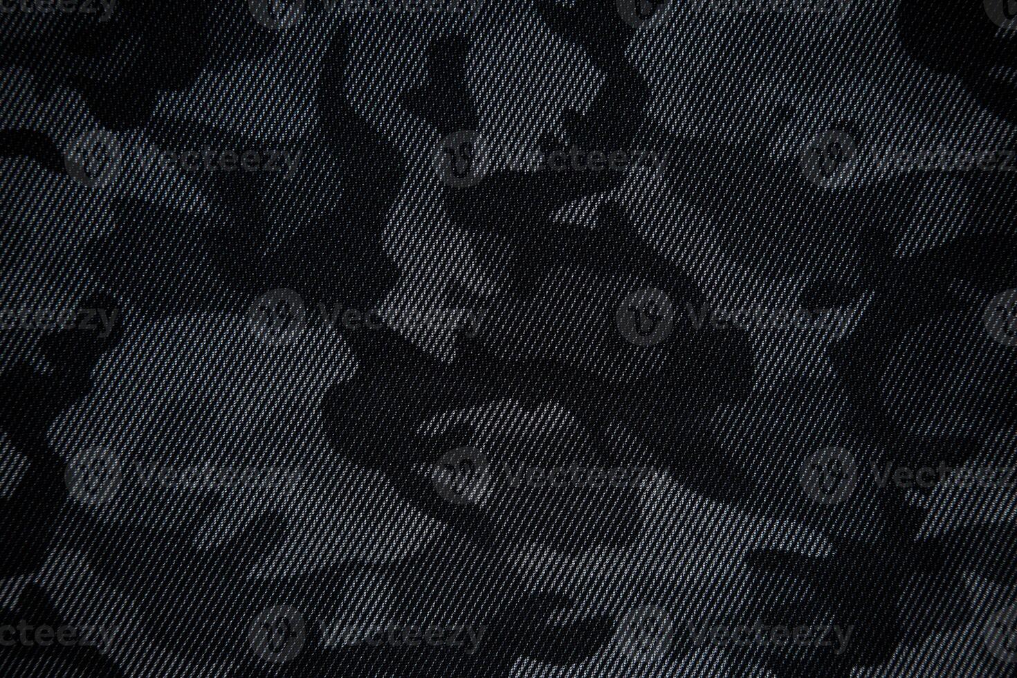 Camouflage pattern. Trendy dark gray camouflage fabric. Military texture. Dark back. photo