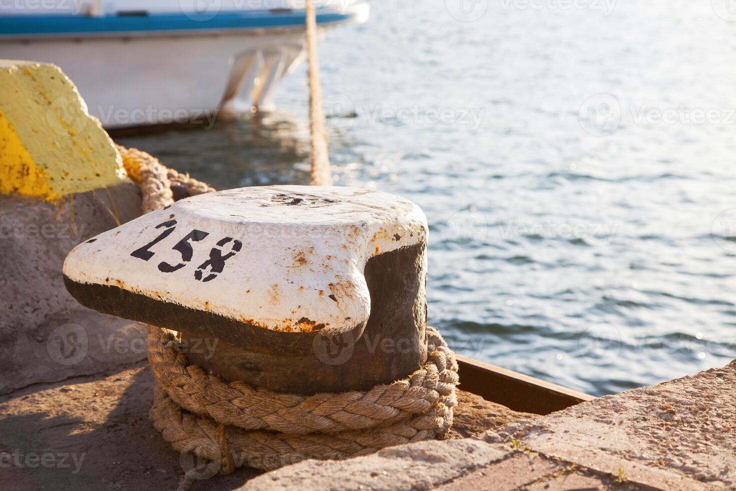 Bollard with mooring on the quay photo