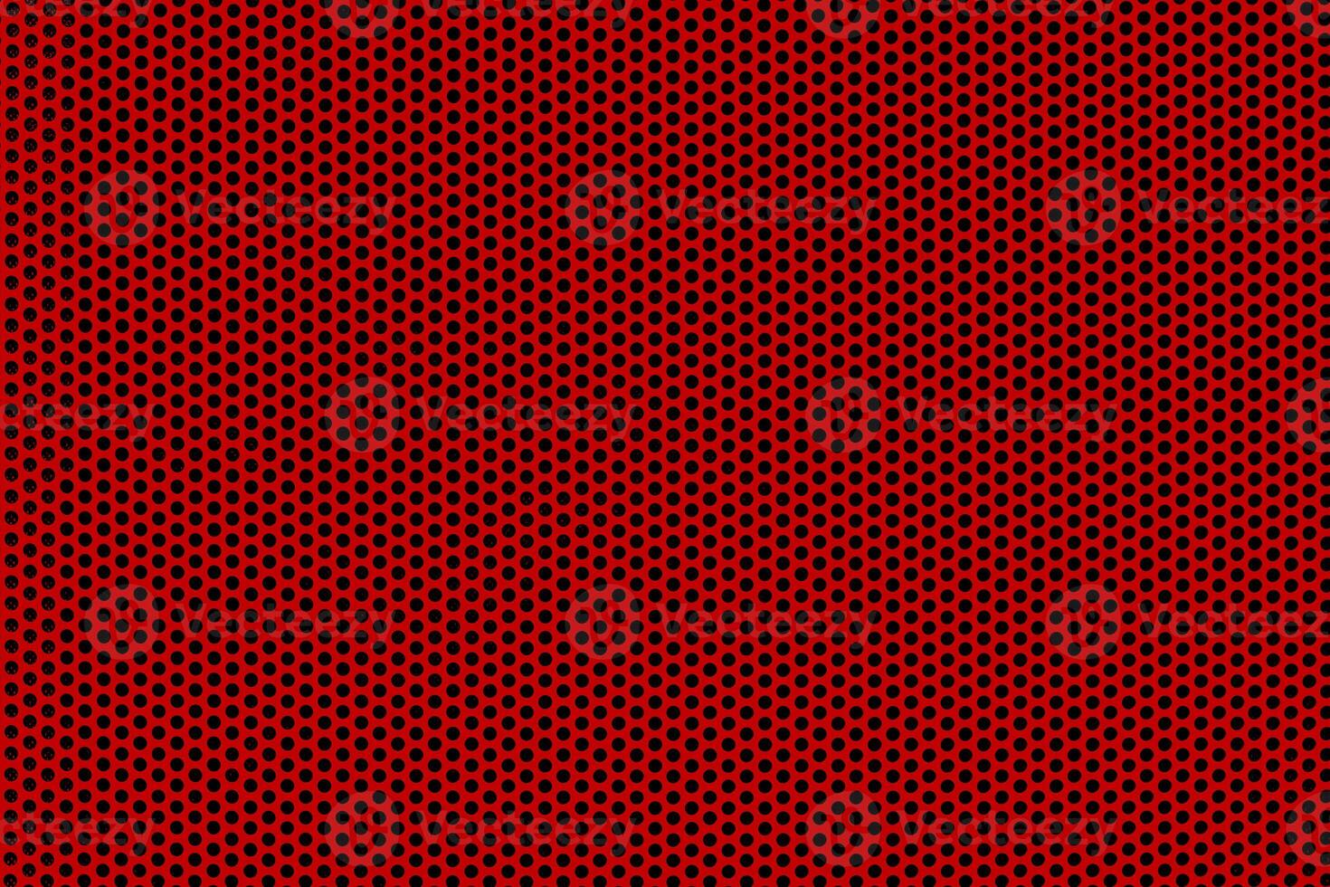 Background of wavy red metallic grid with holes. Perforated metal back. Metal mesh as background. photo