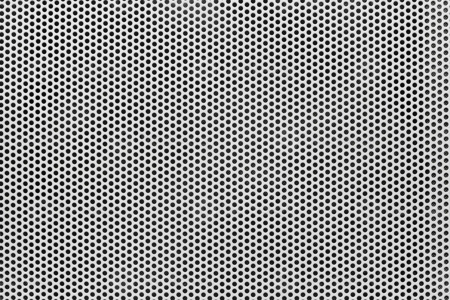 Background of wavy metallic grid with holes. Metal mesh as back. Perforated metal back. photo