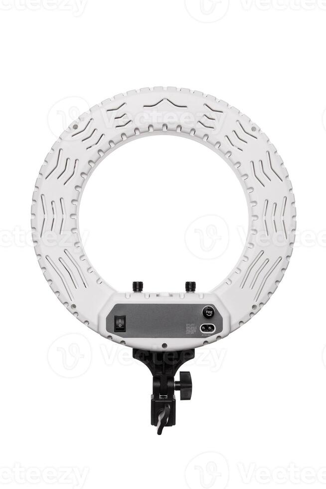 Closeup of circular neon LED lamp isolated white background. Popular modern light for make-up and beauty portraits. photo