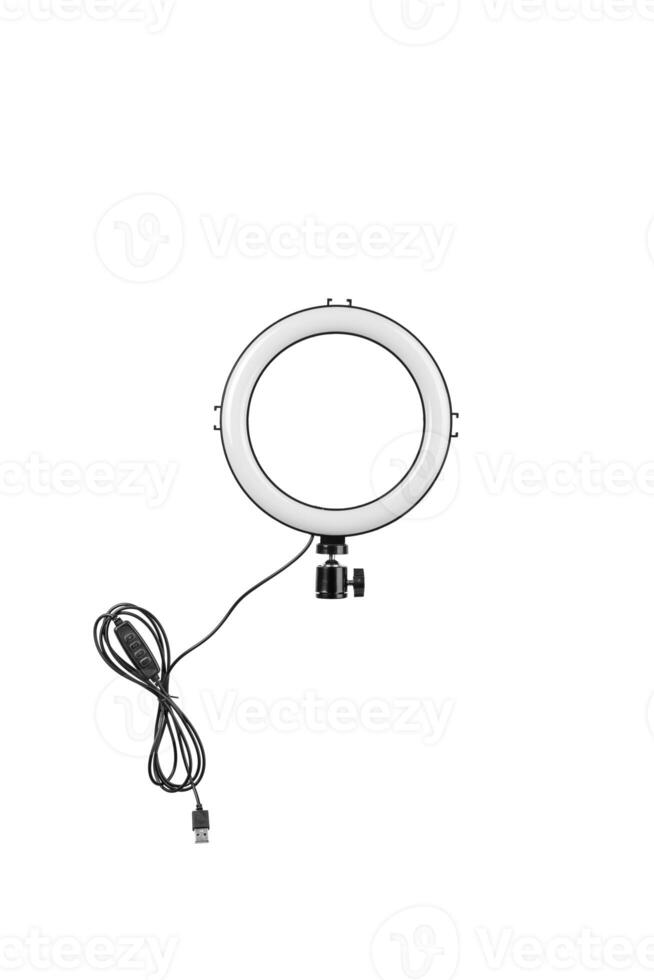 Closeup of circular neon LED lamp isolated white background. Popular modern light for make-up and beauty portraits. photo