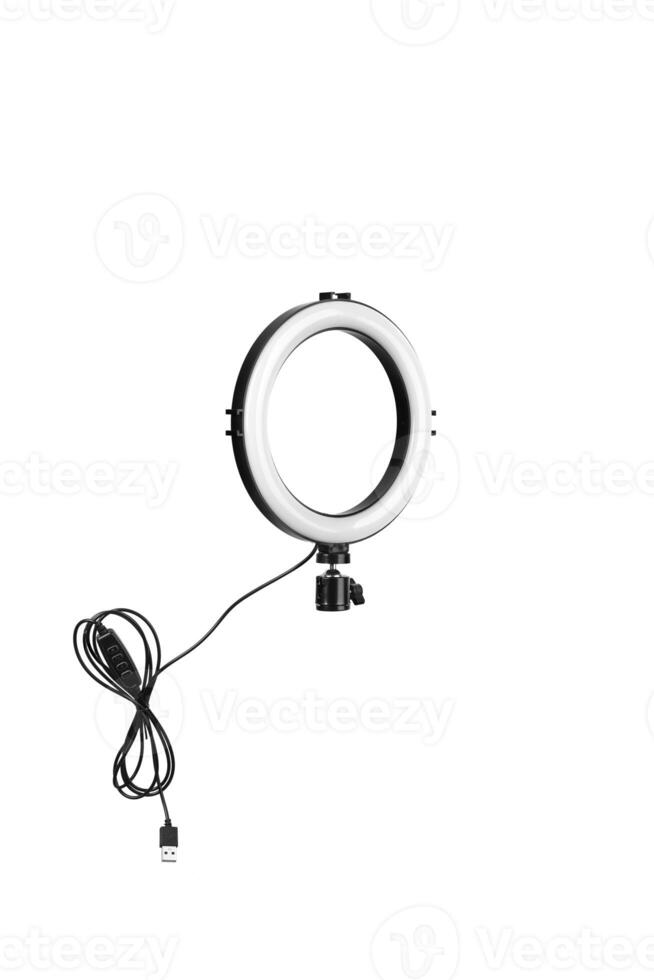 Closeup of circular neon LED lamp isolated white background. Popular modern light for make-up and beauty portraits. photo