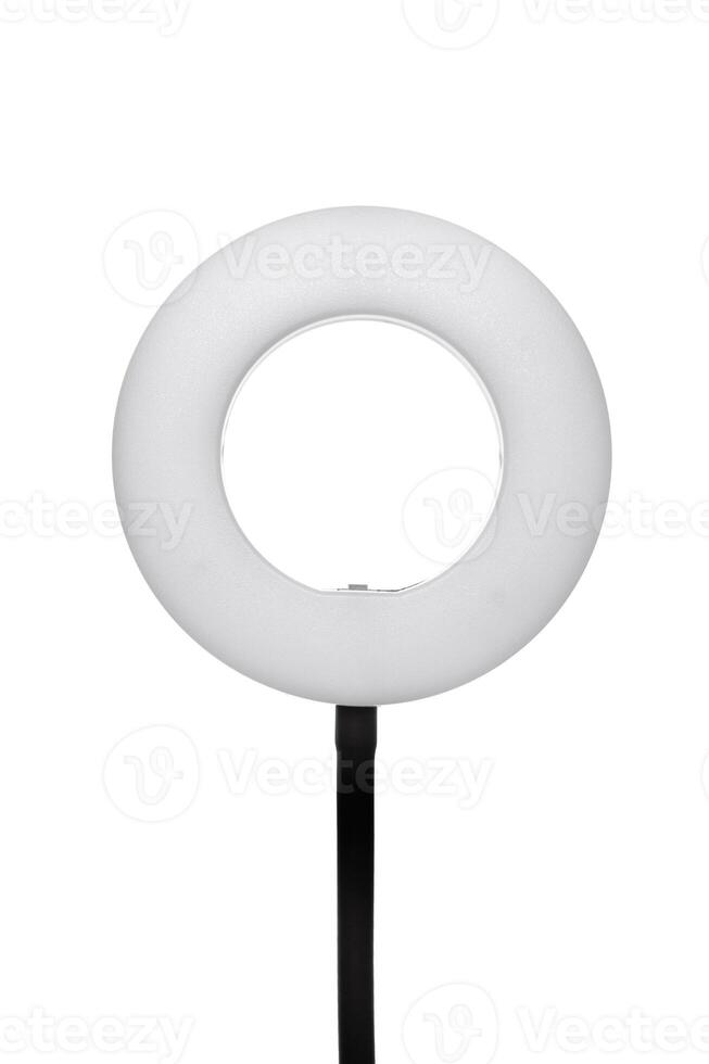 Closeup of circular neon LED lamp isolated white background. Popular modern light for make-up and beauty portraits. photo