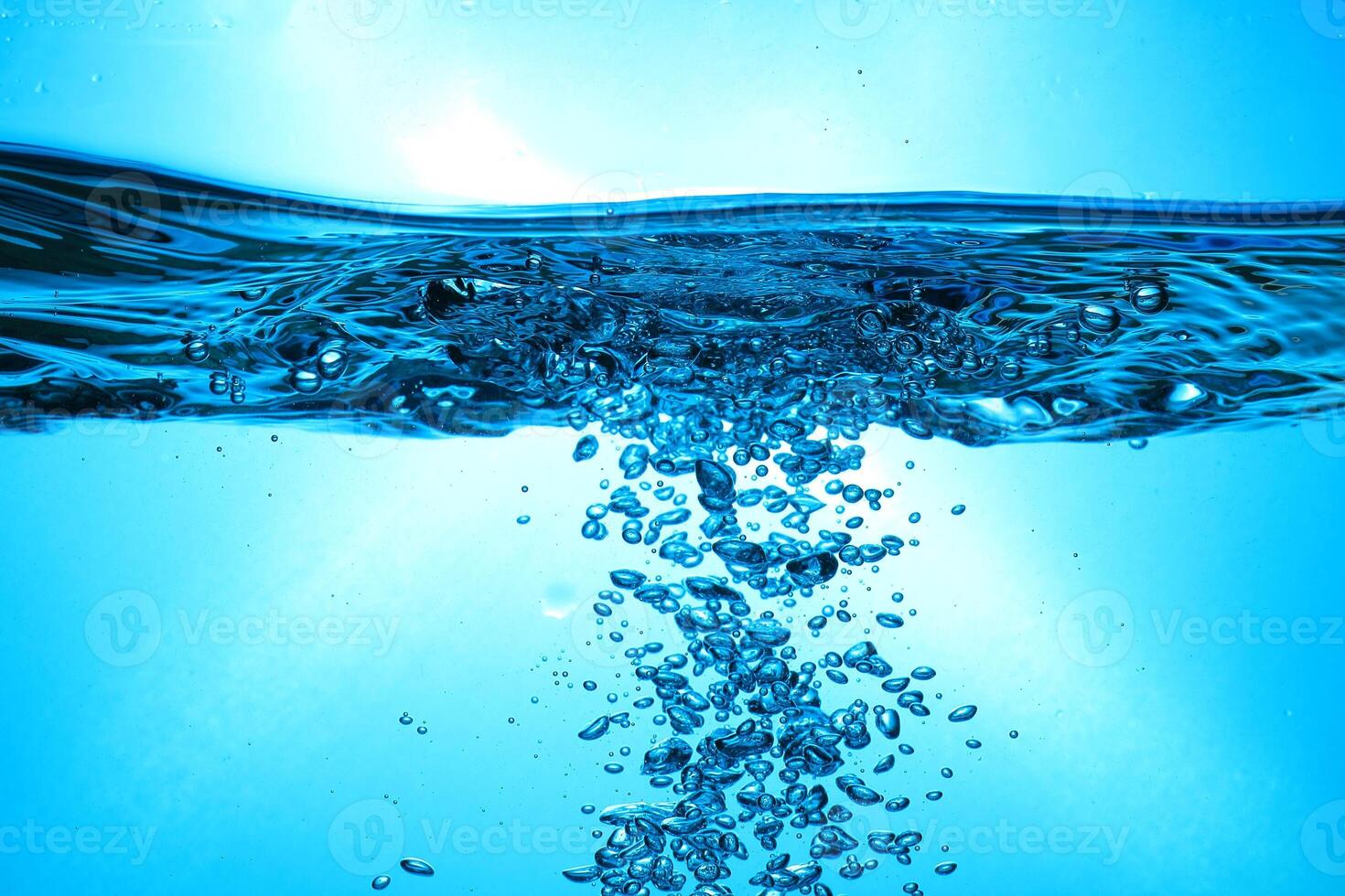 Fresh Water With Underwater Bubbles Texture on a Blue Background Close-up Abstract Liquid Bubbles Aqua Design Wallpaper photo