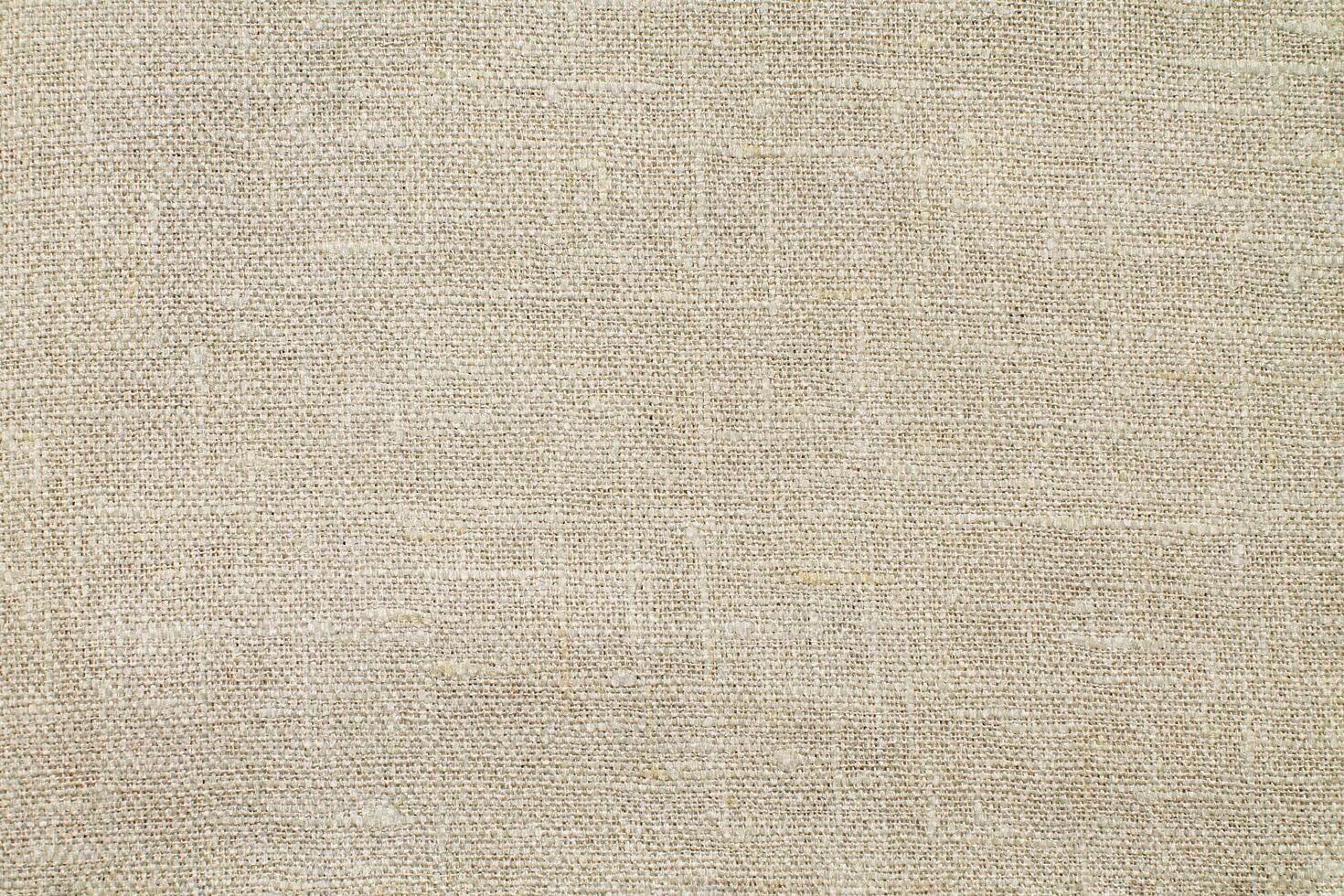 Natural Linen Material Textile Canvas Fabric Texture Background Close-up Detail of Fabric Natural Color Hemp Material Pattern Design Wallpaper. Can be Used as Background or For Graphic Design photo