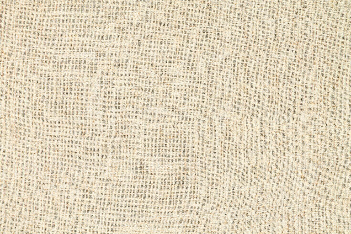 Natural Linen Material Textile Canvas Fabric Texture Background Close-up Detail of Fabric Natural Color Hemp Material Pattern Design Wallpaper. Can be Used as Background or For Graphic Design photo
