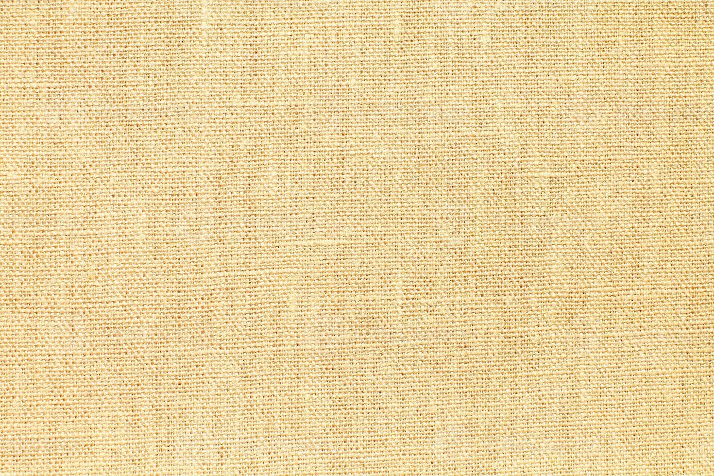 Natural Linen Material Textile Canvas Fabric Texture Background Close-up Detail of Fabric Natural Color Hemp Material Pattern Design Wallpaper. Can be Used as Background or For Graphic Design photo