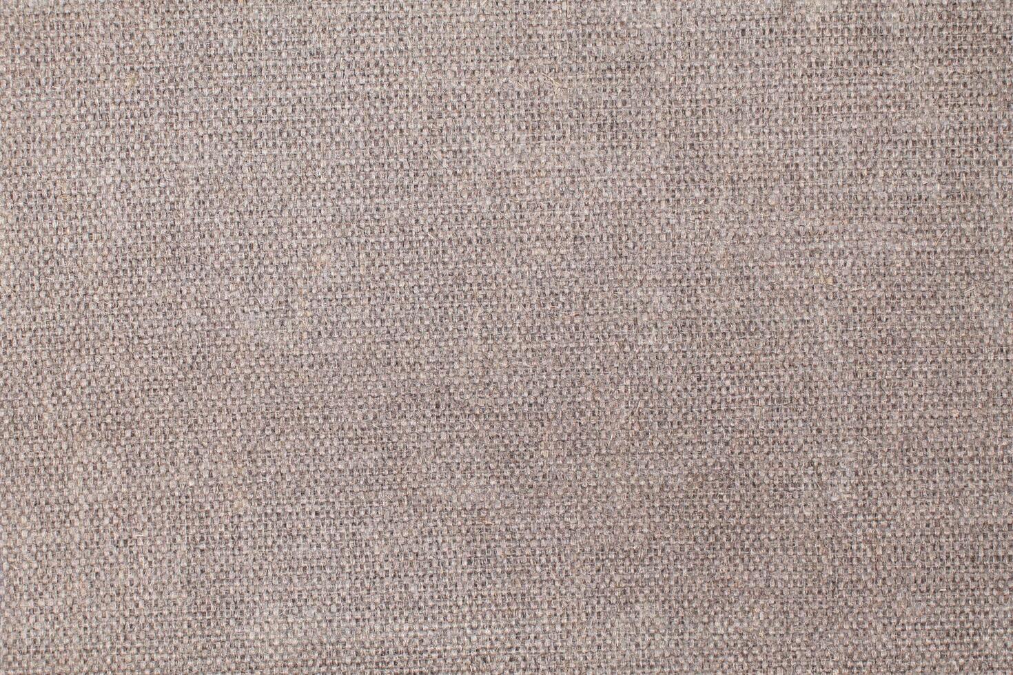 Natural Linen Material Textile Canvas Fabric Texture Background Close-up Detail of Fabric Natural Color Hemp Material Pattern Design Wallpaper. Can be Used as Background or For Graphic Design photo