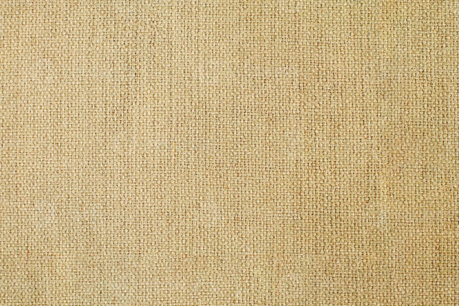 Natural Linen Material Textile Canvas Fabric Texture Background Close-up Detail of Fabric Natural Color Hemp Material Pattern Design Wallpaper. Can be Used as Background or For Graphic Design photo