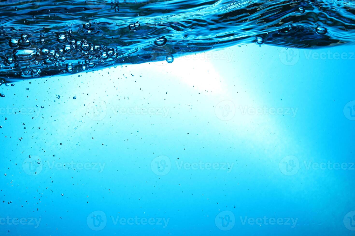Fresh Water With Underwater Bubbles Texture on a Blue Background Close-up Abstract Liquid Bubbles Aqua Design Wallpaper photo